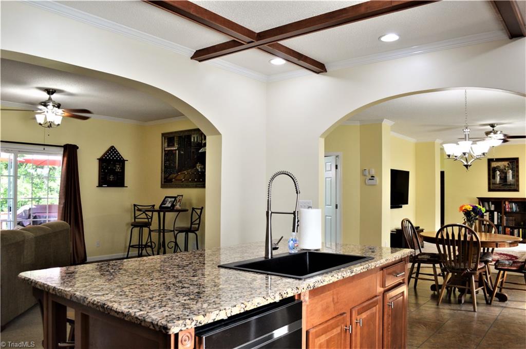 1387 Stewart Road Walnut Cove, NC 27052 - Photo 8 of 30 Kitchen is open to dining and den through the arched doorways