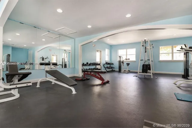 a room with lots of table chairs and a large window