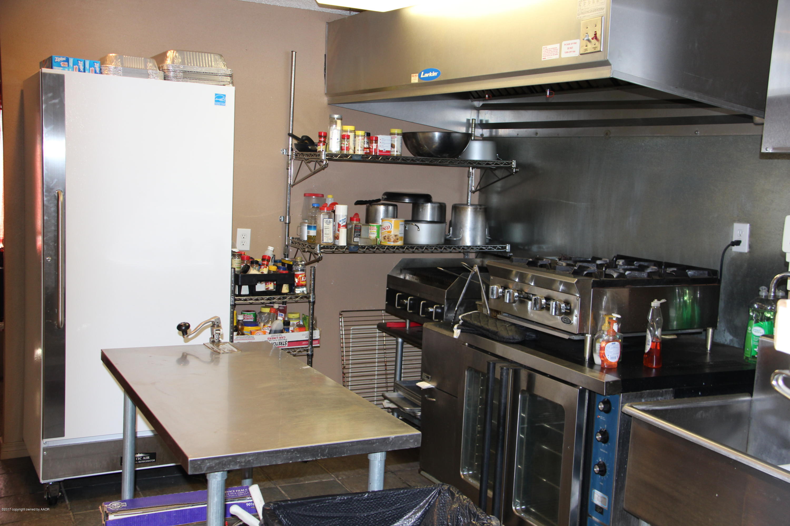 4118 South Washington Street Amarillo, TX 79110 - Photo 4 of 18 a kitchen with stainless steel appliances granite countertop a stove and a refrigerator