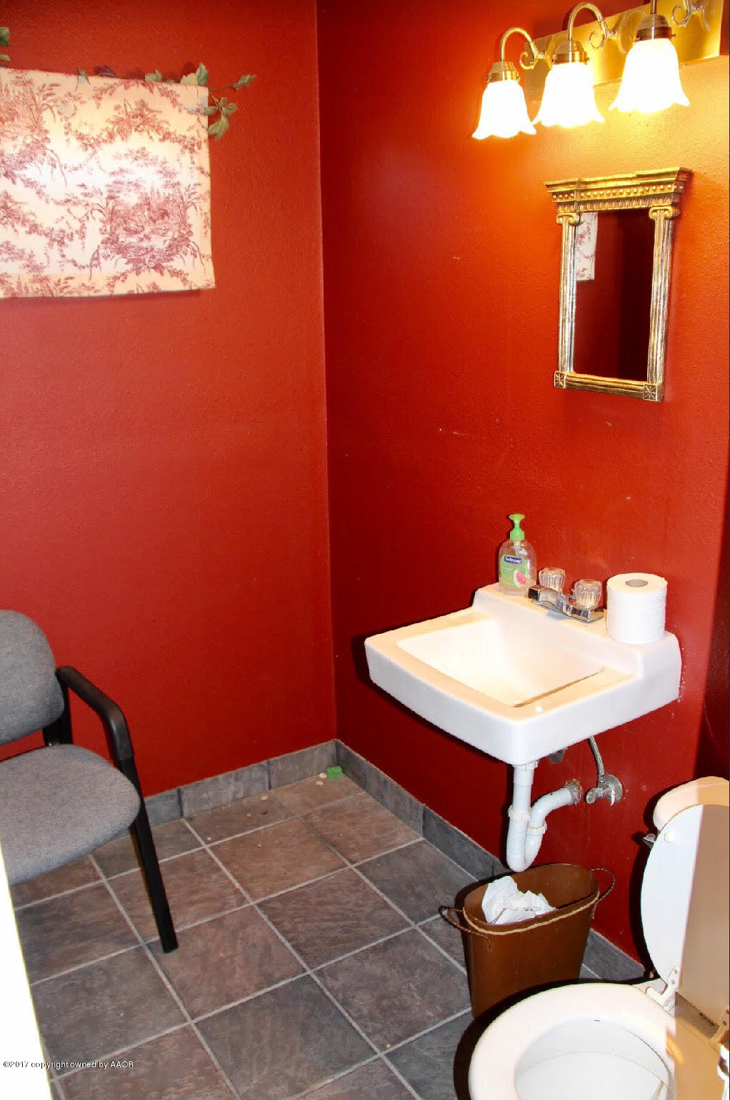 4118 South Washington Street Amarillo, TX 79110 - Photo 6 of 18 a bathroom with a sink a toilet and a mirror