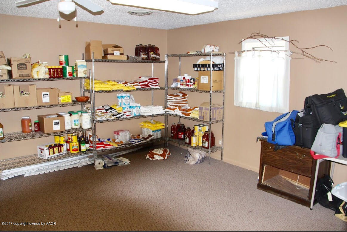 4118 South Washington Street Amarillo, TX 79110 - Photo 10 of 18 a storage room with lots of different colored cloths