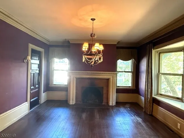a living room with wooden floors and a fireplace