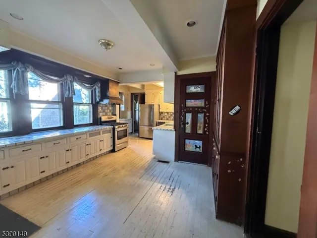 a view of a kitchen with cabinets and wooden floor