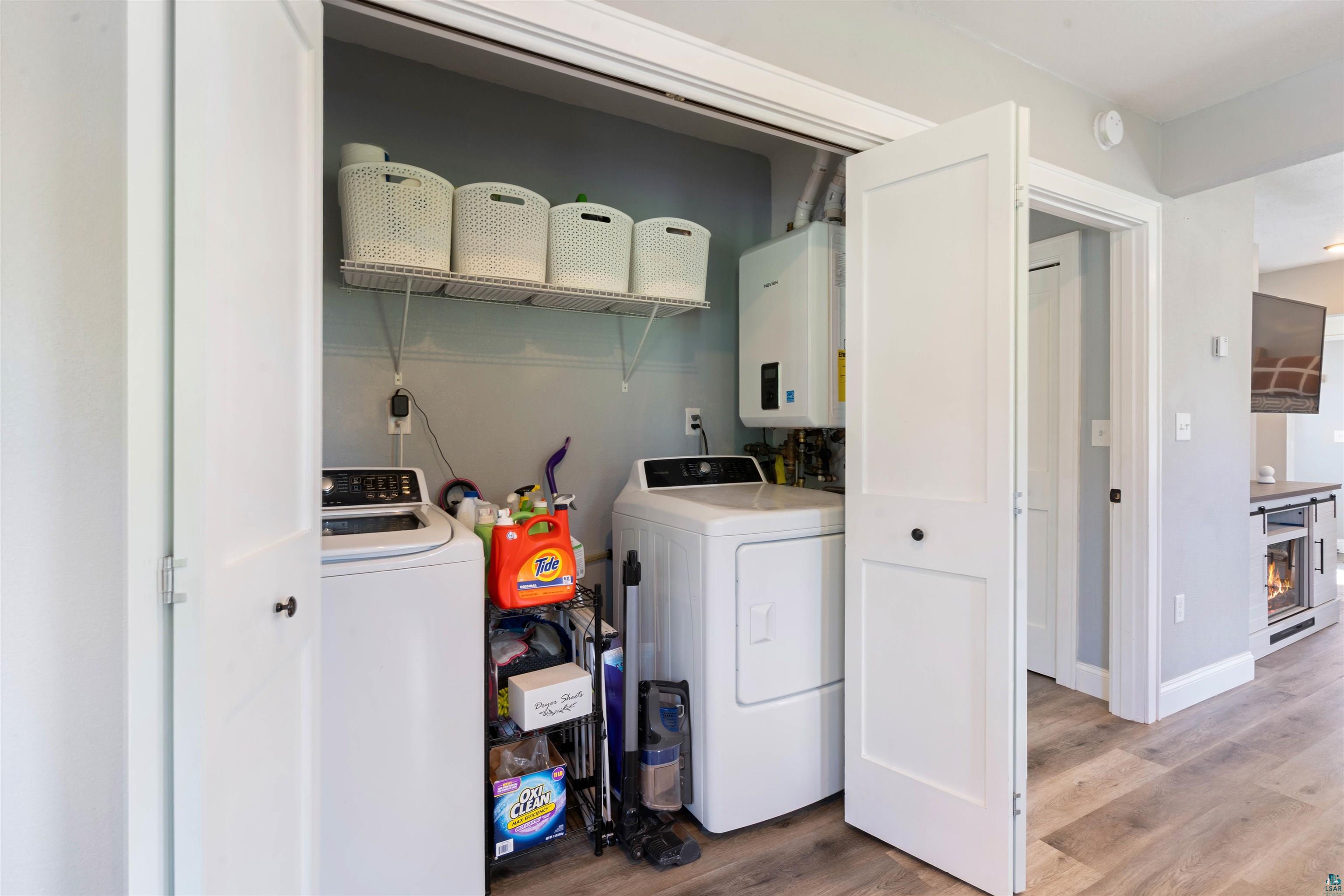 3835 South County Rd K South Range, WI 54874 - Photo 18 of 29 Dedicated laundry closet featuring a top-load washing machine, front-load dryer, and wall-mounted shelving