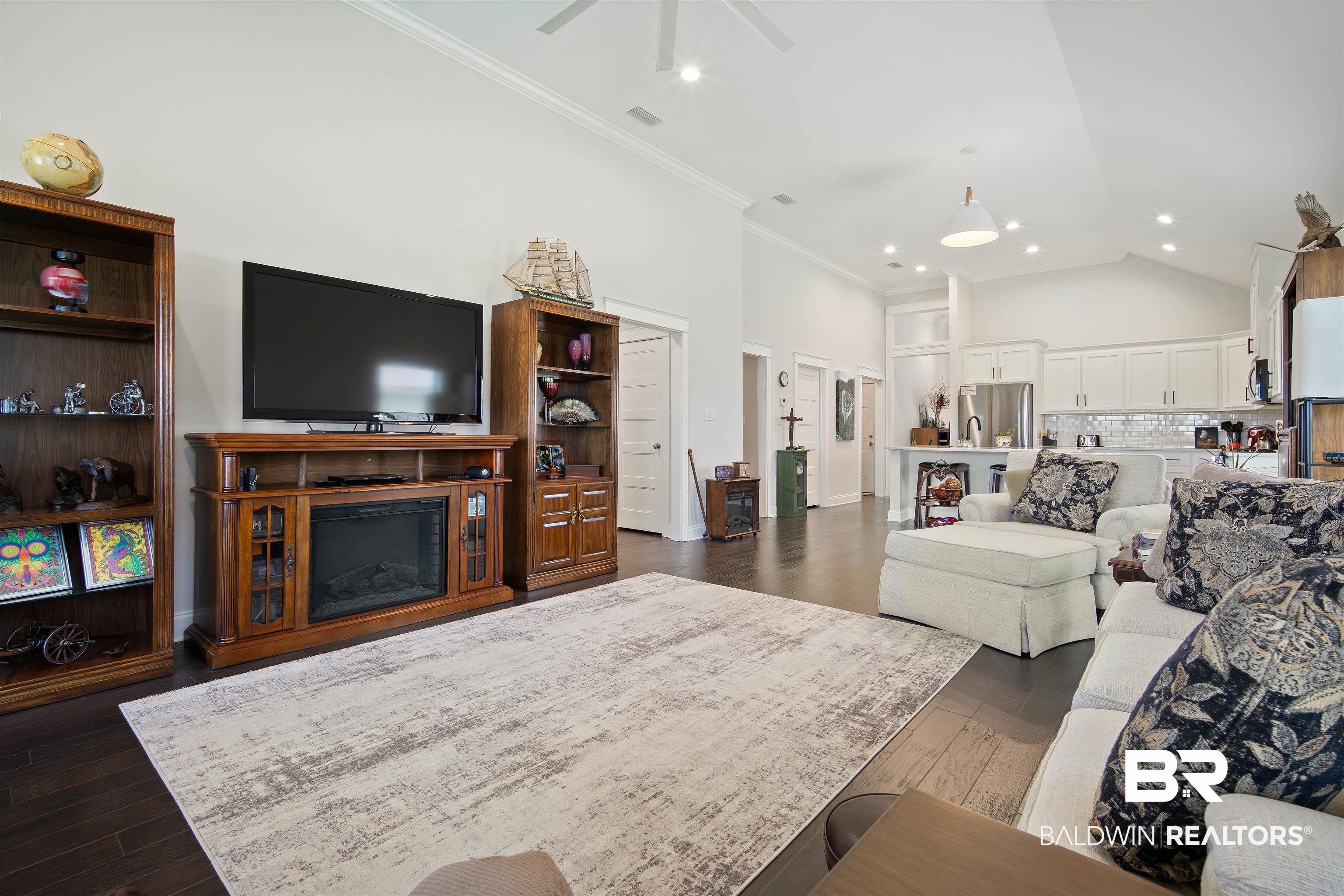 969 Charleston Loop Fairhope, AL 36532 - Photo 6 of 30 Living room with high vaulted ceiling, ceiling fan, dark hardwood / wood-style flooring, and ornamental molding