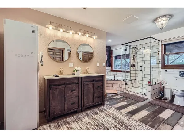 a bathroom with a sink a vanity and a large mirror