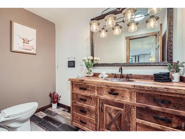 a bathroom with a sink a toilet and mirror