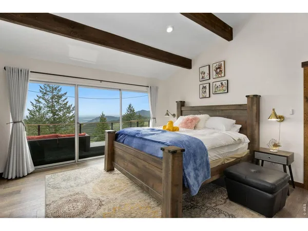 a bedroom with a bed and a large window