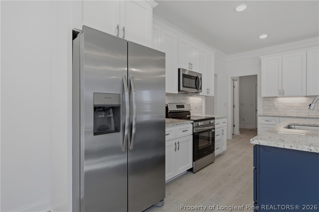 3187 Leaflet Church Road Broadway, NC 27505 - Photo 10 of 27 a kitchen with a refrigerator sink and stainless steel appliances