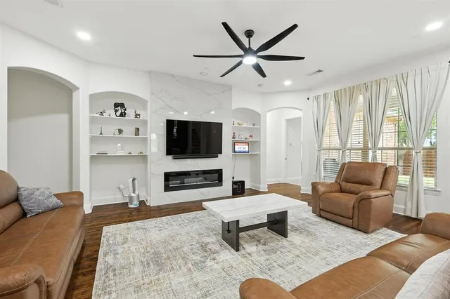 a living room with furniture and a flat screen tv