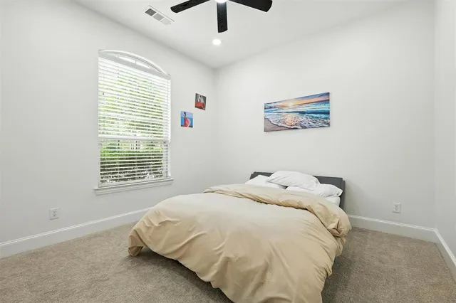 a bed sitting in a bedroom next to a window