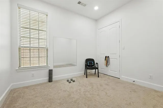 a view of a livingroom with a lounge chair and a window