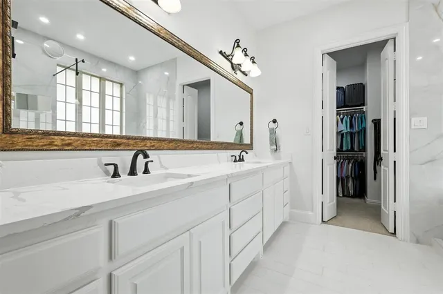 a spacious bathroom with a double vanity sink and a mirror