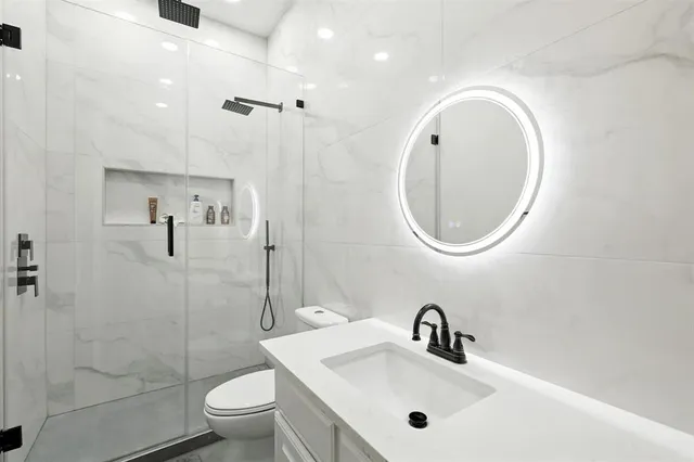 a bathroom with a sink a toilet and a mirror