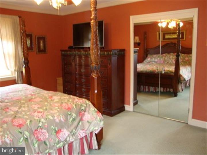 1314 Youngs Ford Road Gladwyne, PA 19035 - Photo 12 of 22 a bedroom with a bed and mirror
