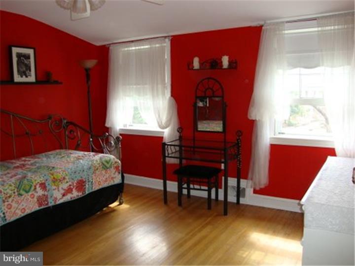 1314 Youngs Ford Road Gladwyne, PA 19035 - Photo 14 of 22 a bedroom with a bed and a dresser next to a window