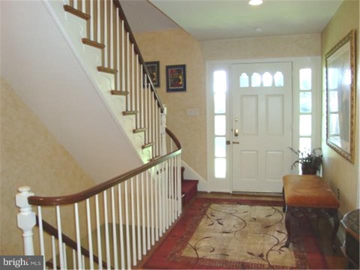 1314 Youngs Ford Road Gladwyne, PA 19035 - Photo 4 of 22 a view of a hallway with wooden floor and windows
