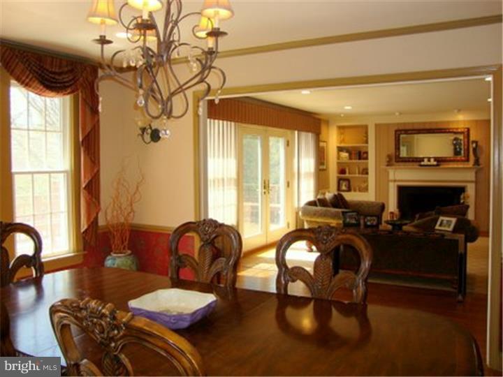 1314 Youngs Ford Road Gladwyne, PA 19035 - Photo 7 of 22 a living room with furniture a fireplace and a large window