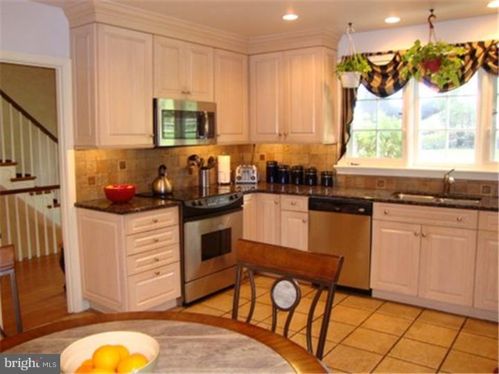 1314 Youngs Ford Road Gladwyne, PA 19035 - Photo 9 of 22 a kitchen with granite countertop wooden cabinets stainless steel appliances a sink and a window