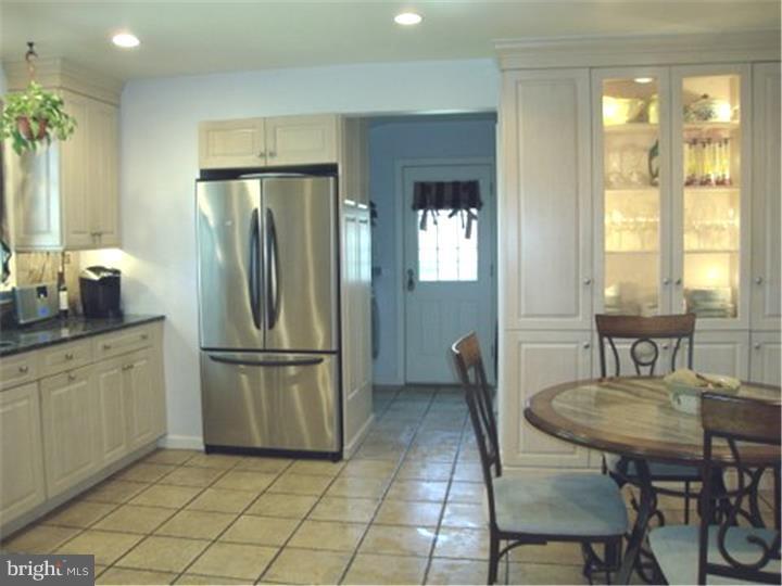 1314 Youngs Ford Road Gladwyne, PA 19035 - Photo 10 of 22 a kitchen with a refrigerator a table and chairs