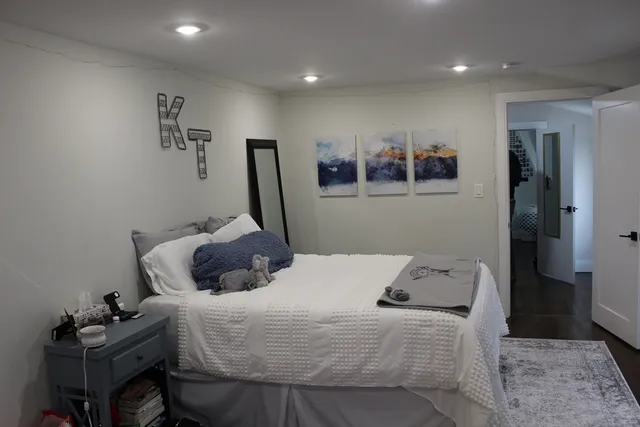 a bedroom with a bed and a view of kitchen