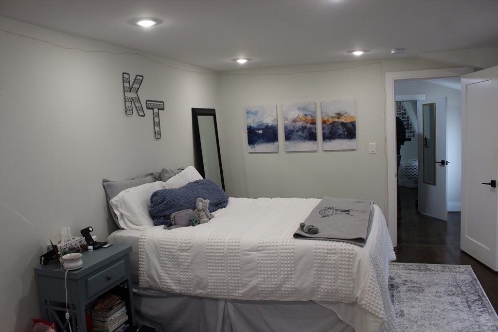 15 Pomeroy Street, Unit 15 Boston, MA 02134 - Photo 3 of 7 a bedroom with a bed and a view of kitchen