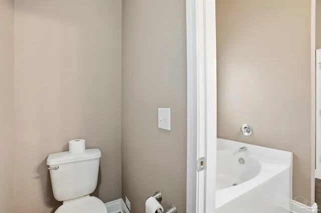 a bathroom with a toilet and bathtub