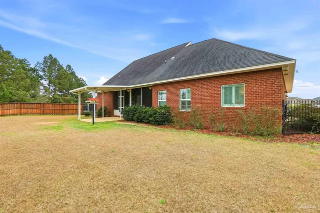 a view of an house with backyard and road