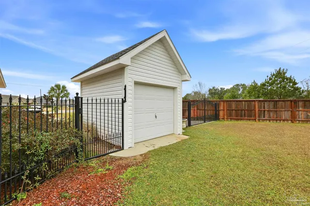 a backyard of a house with wooden fence