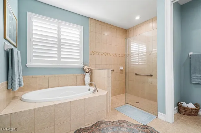 a bathroom with a tub shower and sink