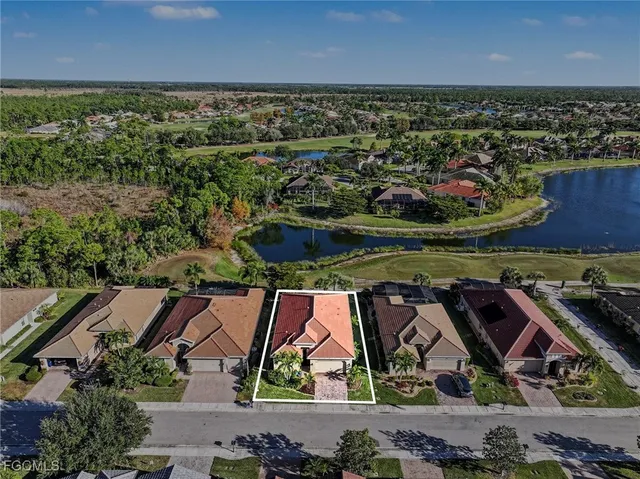 an aerial view of residential house with outdoor space and lake view