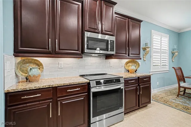 a kitchen with granite countertop stainless steel appliances and wooden cabinets