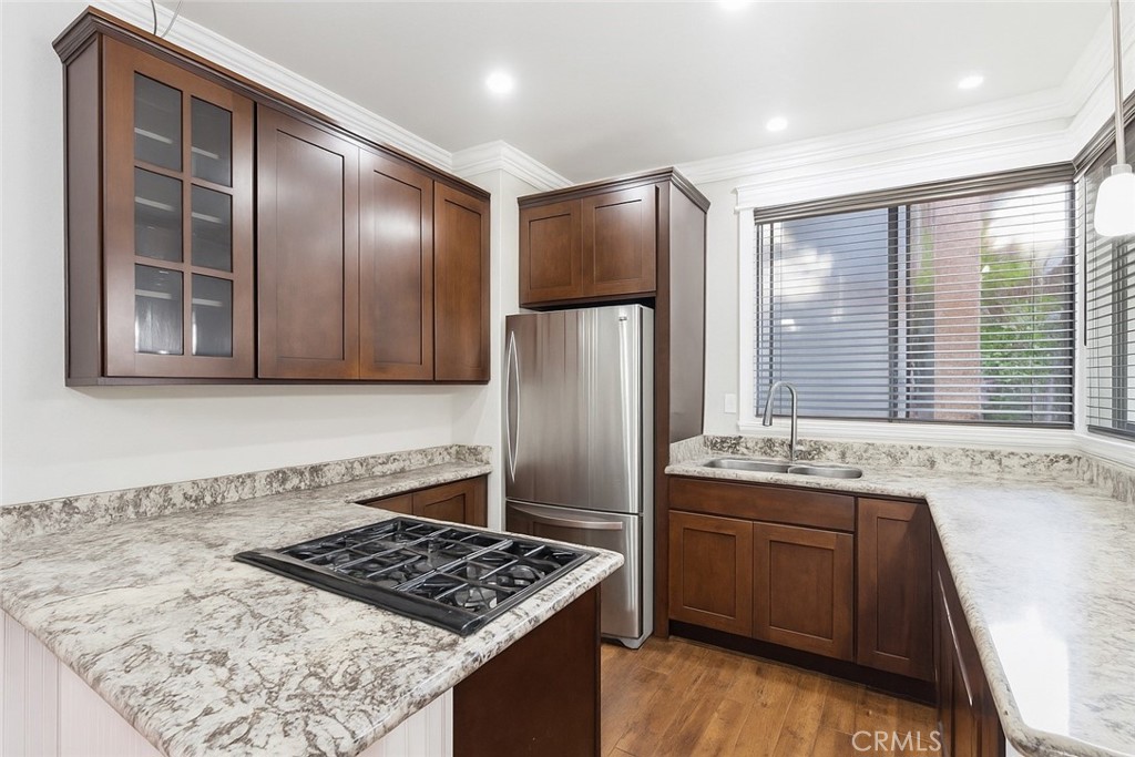 a kitchen with stainless steel appliances granite countertop a stove a refrigerator and a sink