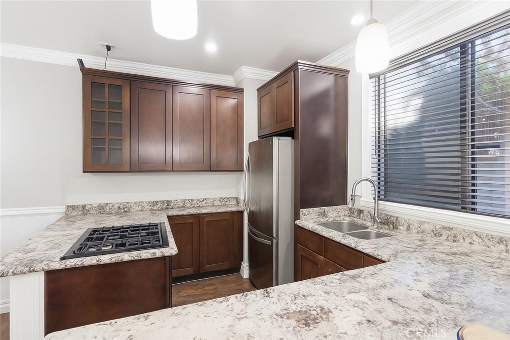 4140 Workman Mill Road, Unit 137 Whittier, CA 90601 - Photo 3 of 20 a kitchen with stainless steel appliances granite countertop a stove a refrigerator and a sink