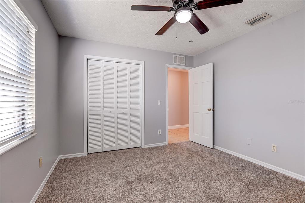 1418 Buckner Road Valrico, FL 33596 - Photo 29 of 37 an empty room with closet and windows