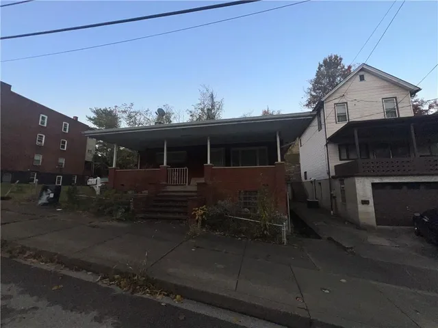 a view of a house with a street