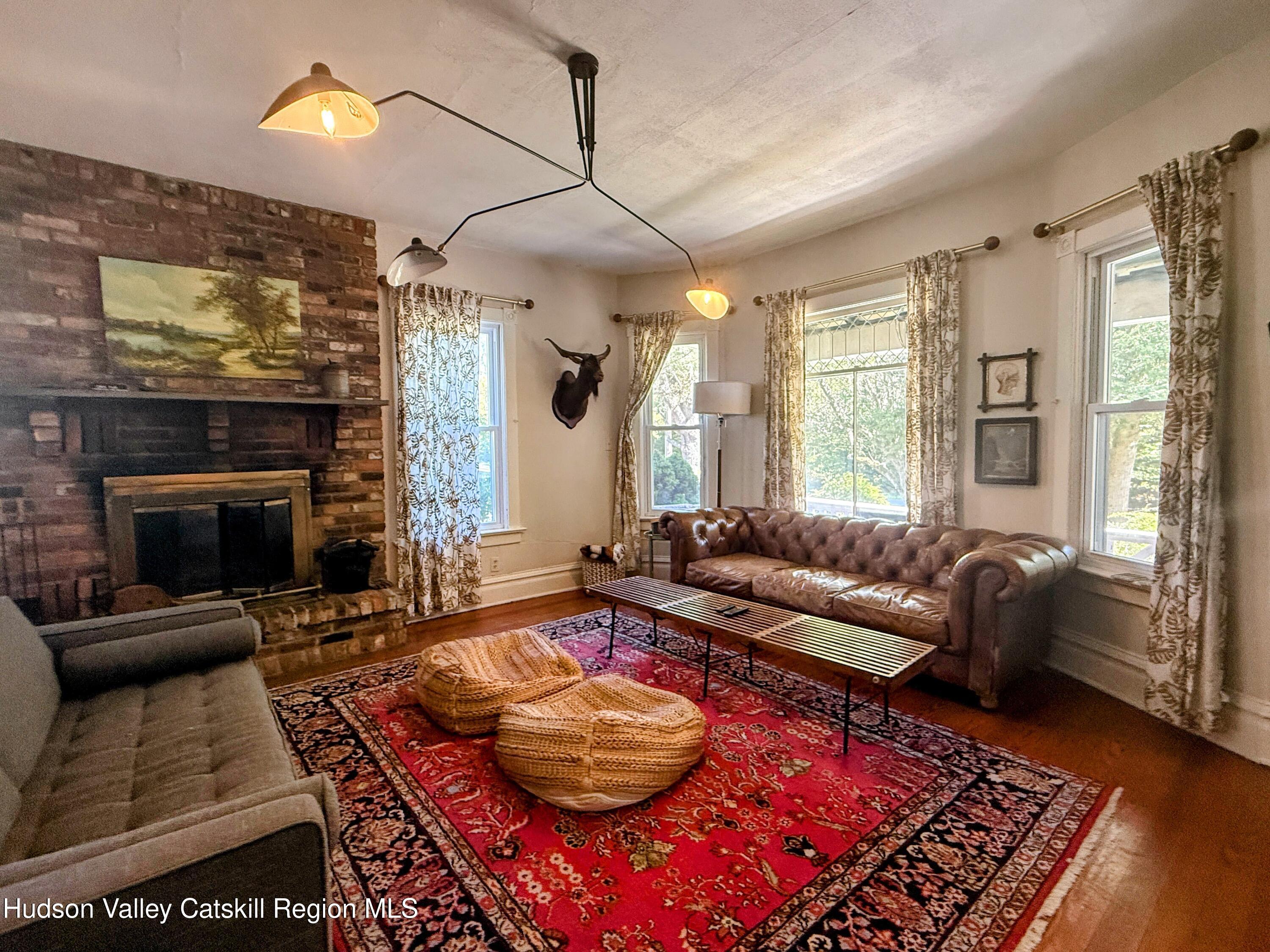 42-50 Stoney Clove Road Hunter, NY 12442 - Photo 11 of 82 a living room with furniture and a fireplace