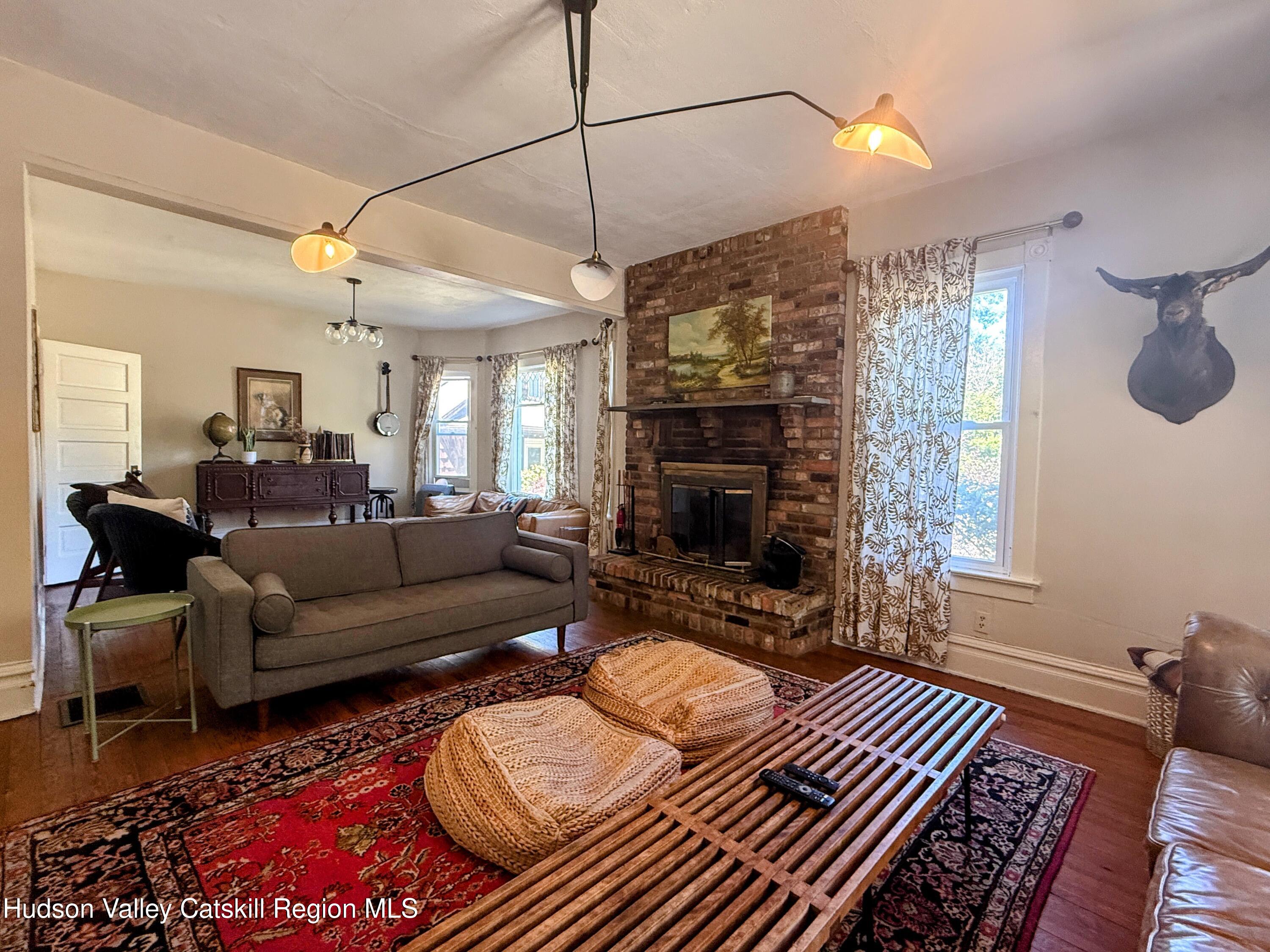42-50 Stoney Clove Road Hunter, NY 12442 - Photo 14 of 82 a living room with furniture a flat screen tv and a fireplace