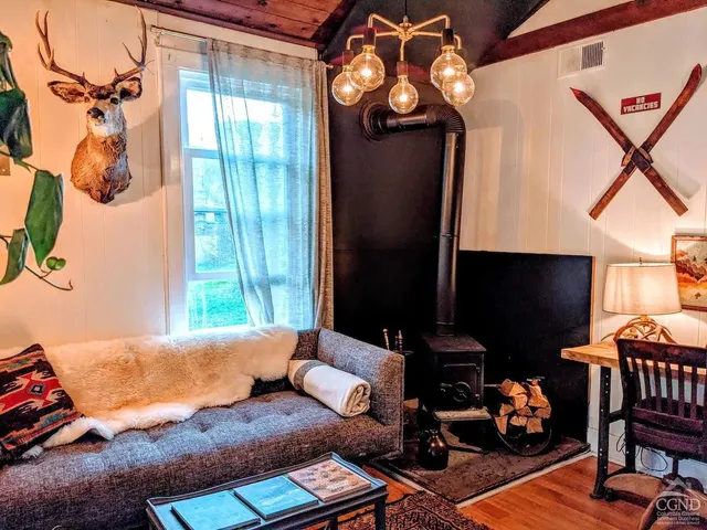a bedroom with a bed wooden floor and window