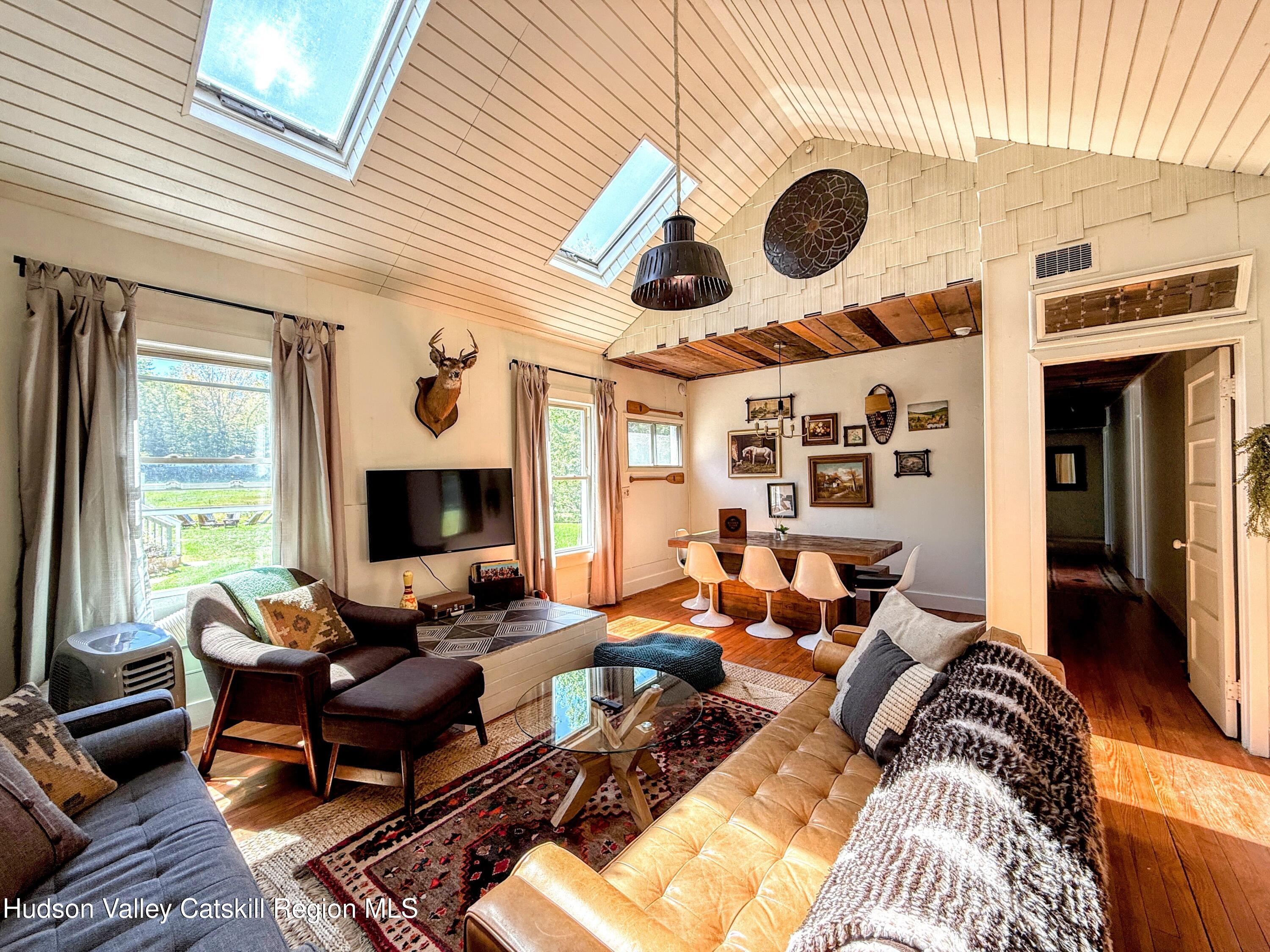 42-50 Stoney Clove Road Hunter, NY 12442 - Photo 30 of 82 a living room with furniture and a fireplace