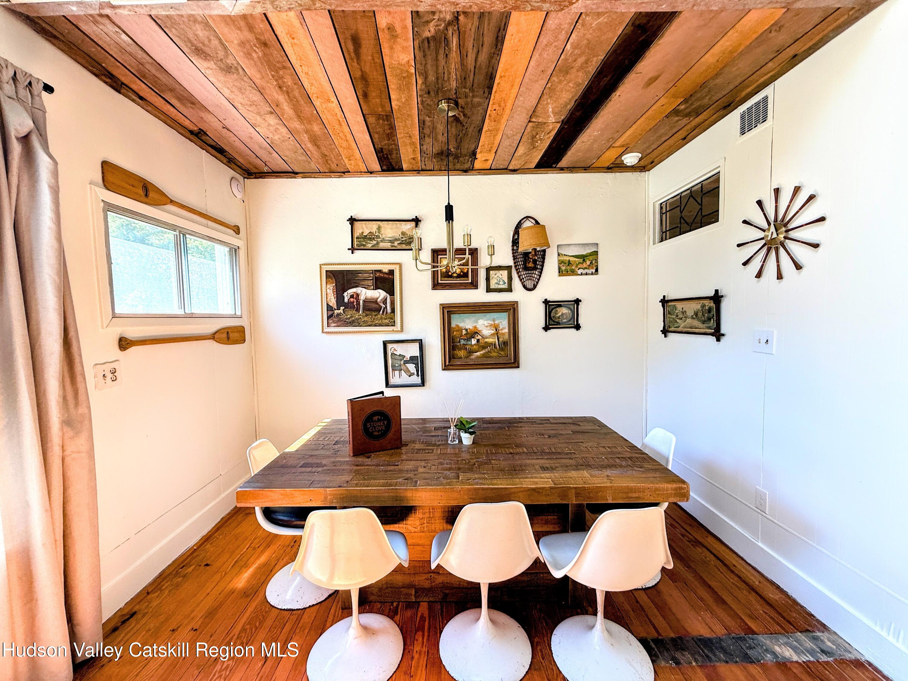 42-50 Stoney Clove Road Hunter, NY 12442 - Photo 31 of 82 a view of a dining room with furniture and wooden floor