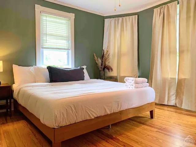 a view of a house with backyard porch and sitting area