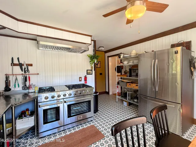 a kitchen with a stove a sink and a dining table