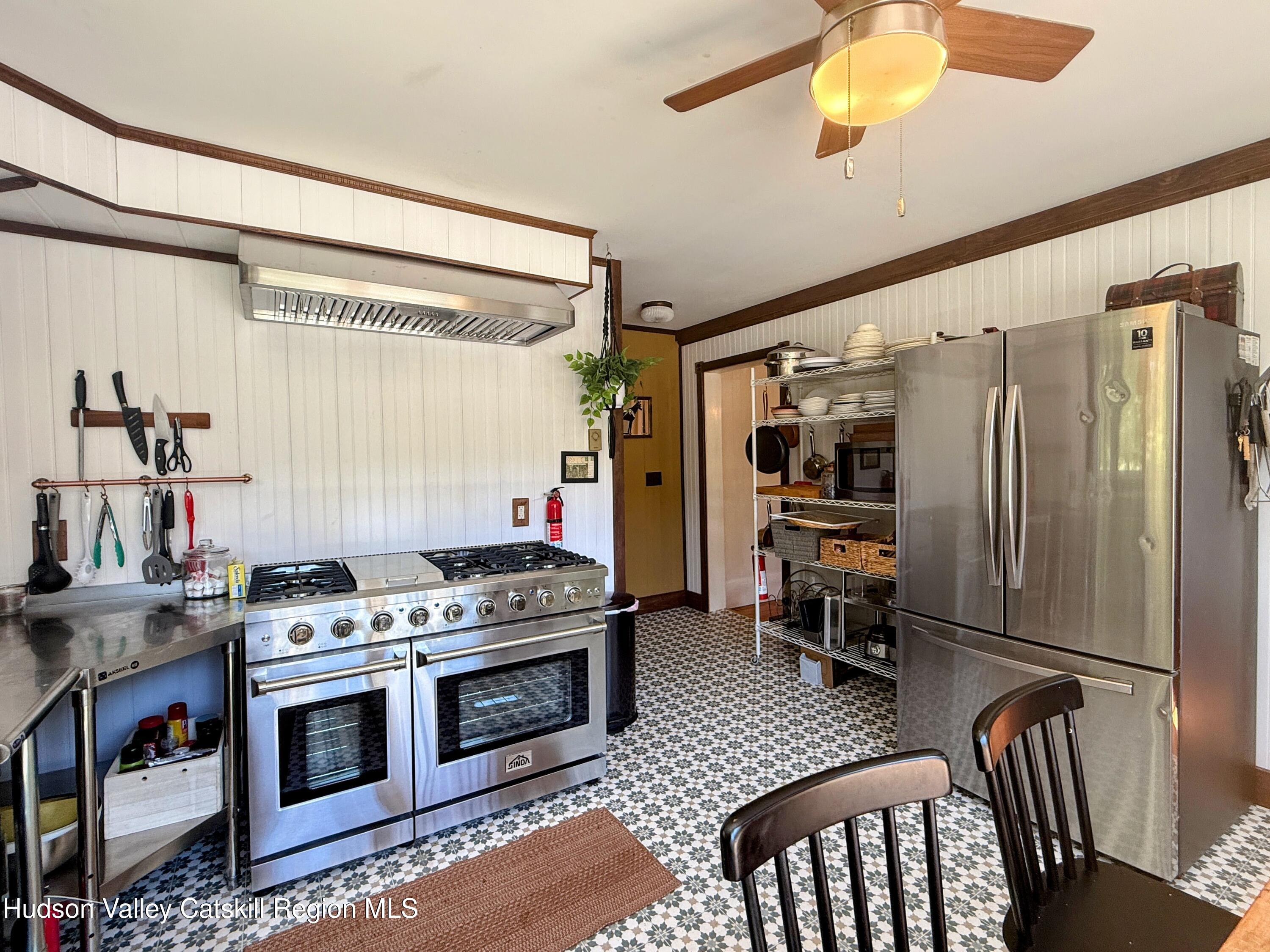 42-50 Stoney Clove Road Hunter, NY 12442 - Photo 6 of 82 a kitchen with stainless steel appliances granite countertop a stove a refrigerator and a dining table