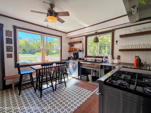 a living room with patio furniture and a fireplace