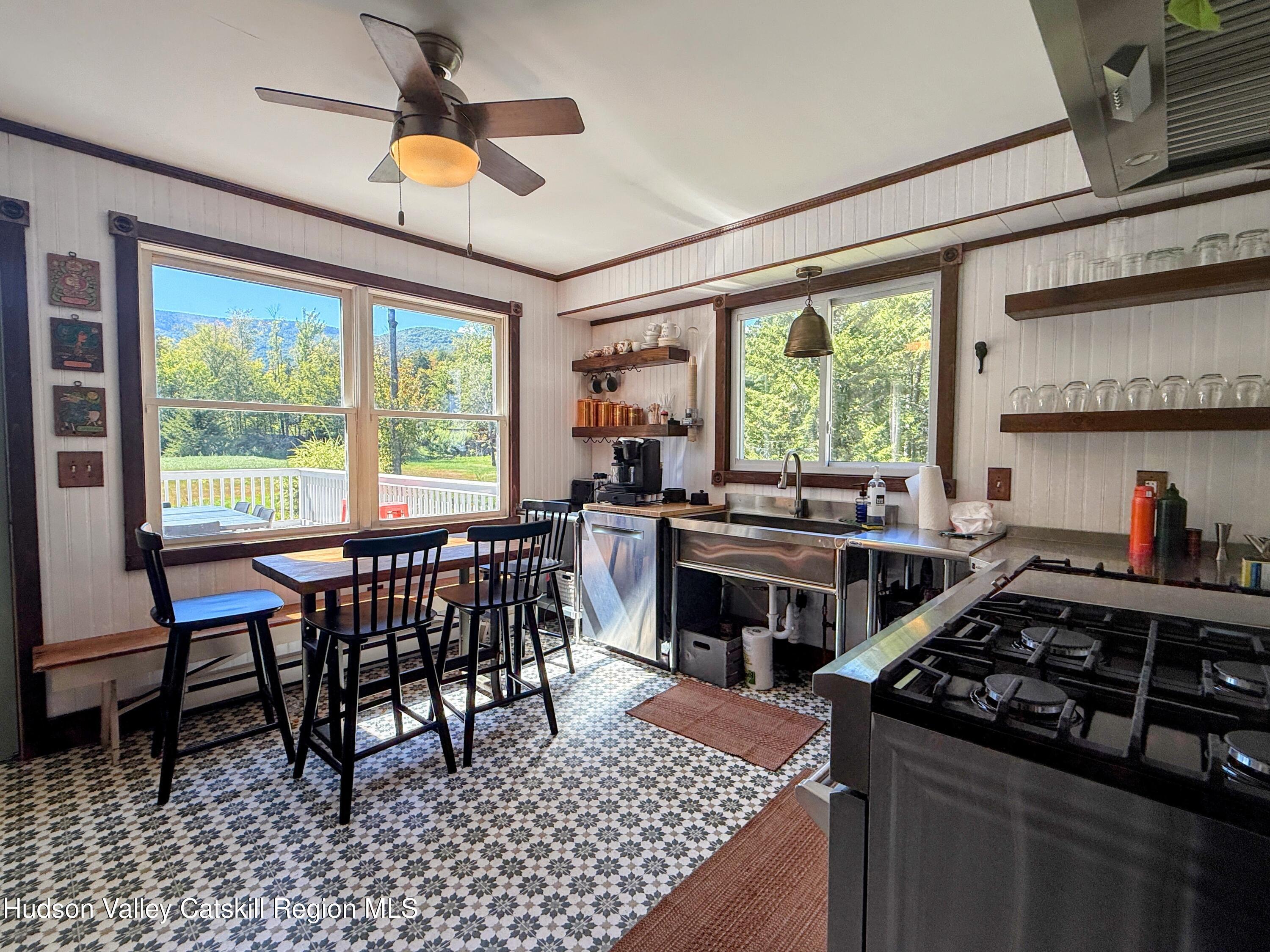 42-50 Stoney Clove Road Hunter, NY 12442 - Photo 7 of 82 a kitchen with a stove a sink and a dining table
