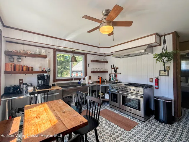a living room with furniture a large window and a fireplace