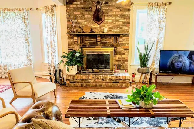 a living room with furniture and a fireplace