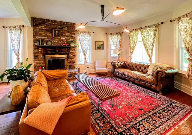 a living room with furniture fireplace and a chandelier