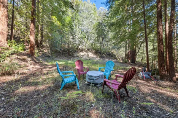 a backyard of a house with table and chairs